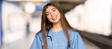 Komik göz bir hastanede olan kameraya gösteren dil genç hemşire