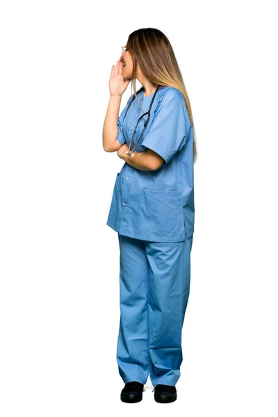 Full body of Young nurse shouting with mouth wide open to the lateral