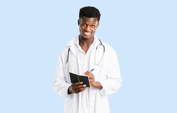 African American Doctor Holding Notebook Isolated Blue Background — Stock Photo, Image