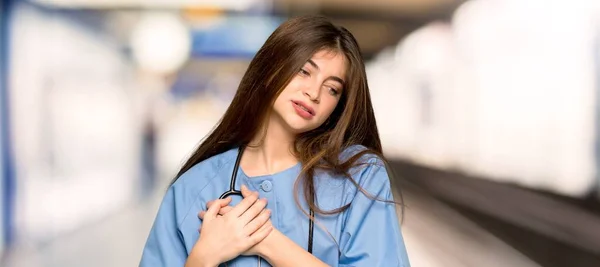 Young nurse having a pain in the heart in a hospital