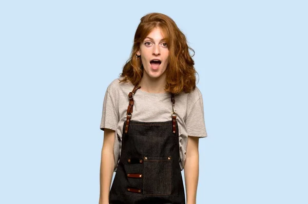 Young Redhead Woman Apron Surprise Shocked Facial Expression Blue Background — Stock Photo, Image
