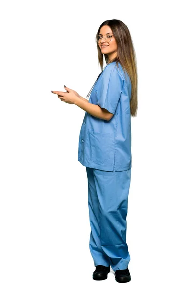 Full body of Young nurse using mobile phone