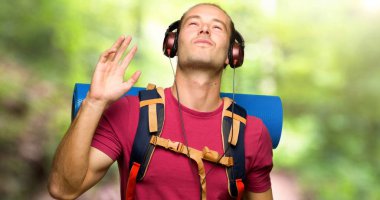 Kulaklık ile müzik dinlemek ve dağın içinde dans dağ backpacker adamla uzun yürüyüşe çıkan kimse