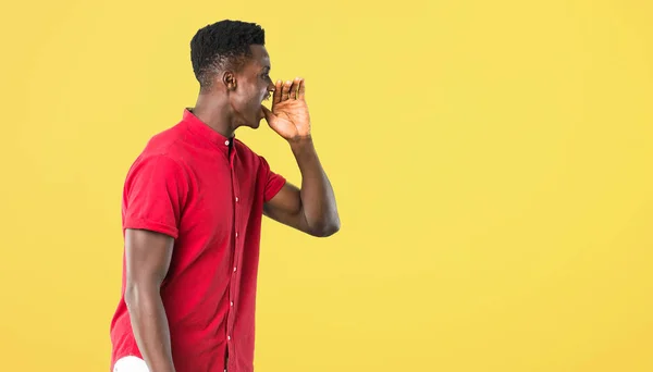 Young african american man shouting with mouth wide open to the — Stock Photo, Image