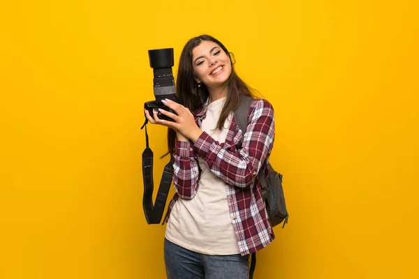 Photographe adolescent fille sur le mur jaune — Photo