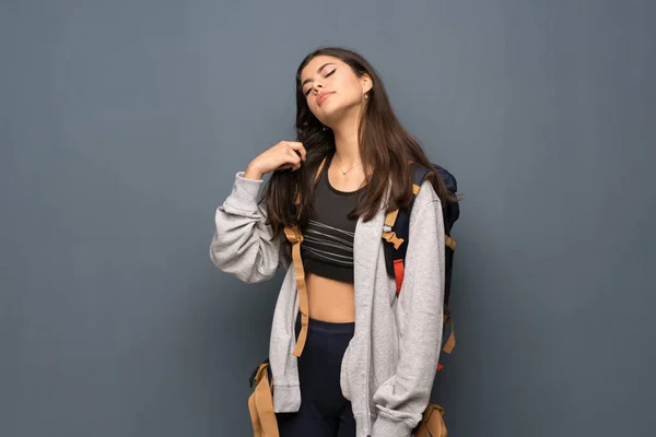 Side view of happy beauty woman in leggings put on hoodie in gray