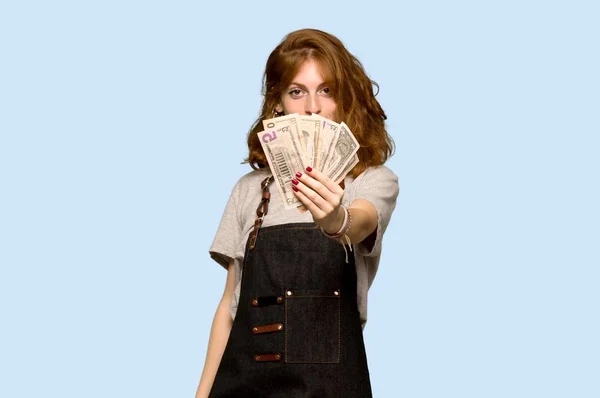 Young Redhead Woman Apron Taking Lot Money Blue Background — Stock Photo, Image