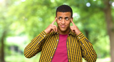 Şüpheleri ve bir parkta düşünme genç afro Amerikalı adam