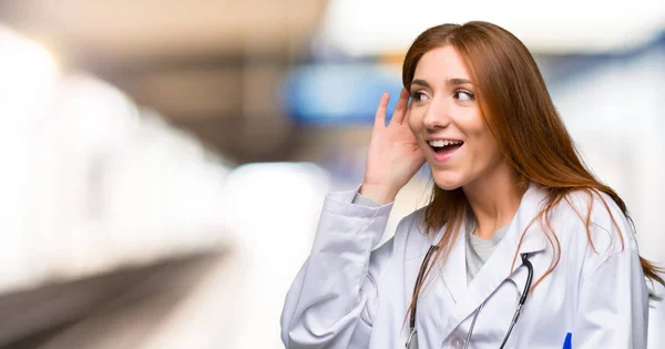 Redhead Doctor Woman Listening Something Putting Hand Ear Hospital — Stock Photo, Image