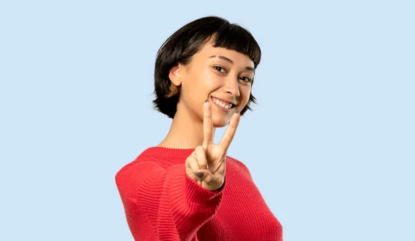 Short Hair Girl Red Sweater Smiling Showing Victory Sign Isolated — Stock Photo, Image