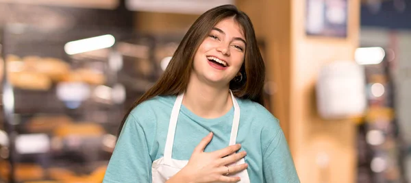 Girl Apron Smiling Lot While Putting Hands Chest Bakery — Stock Photo, Image