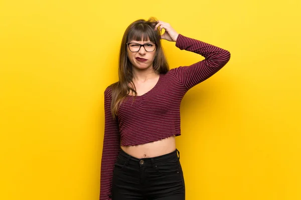 Kobieta Okularach Żółte Ściany Mając Wątpliwości Myślenia — Zdjęcie stockowe
