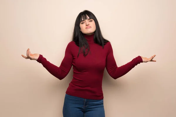 Young woman with red turtleneck unhappy and frustrated with something because not understand something
