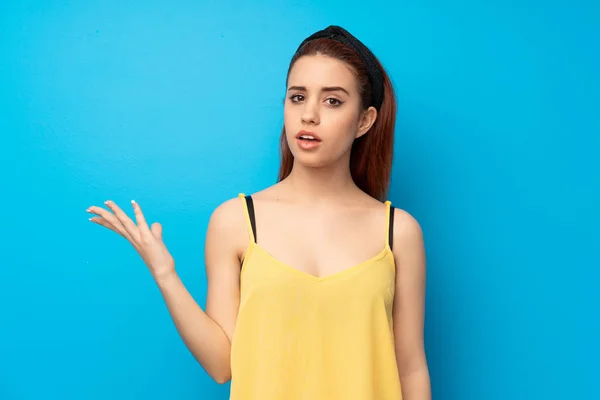 Young Redhead Woman Blue Background Making Doubts Gesture — Stock Photo, Image