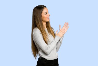 genç kız mavi zemin üzerine bir konferansta sunum sonrası alkış