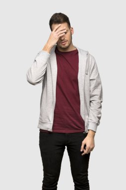 Adam yorgun ve hasta ifade gri arka plan üzerinde ile kazak ile