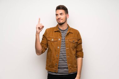 Gösteren ve en iyi iz içinde parmak kaldırma beyaz duvar yakışıklı adam