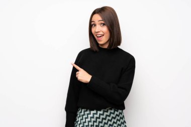 Beyaz duvar şaşırmış ve işaret parmak tarafa genç kadın