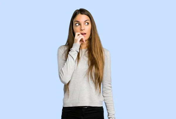 Young Girl Having Doubts While Looking Blue Background — Stock Photo, Image