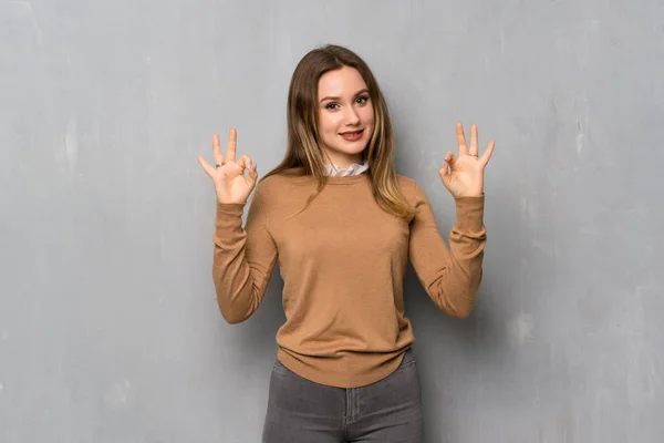 Adolescente Chica Sobre Textura Pared Mostrando Signo Con Los Dedos —  Fotos de Stock