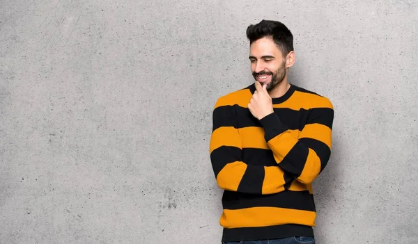 Handsome Man Striped Sweater Looking Side Hand Chin Textured Wall — Stock Photo, Image