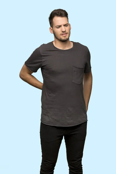 Man Black Shirt Suffering Backache Having Made Effort Blue Background — Stock Photo, Image