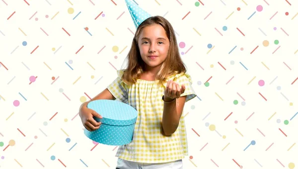 Little girl at a birthday party holding a gift presenting and inviting to come on colorful background