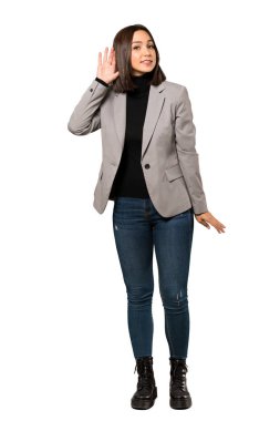 Bir şey izole beyaz arka plan üzerinde kulak el koyarak dinleme genç iş kadını tam uzunlukta bir kadeh