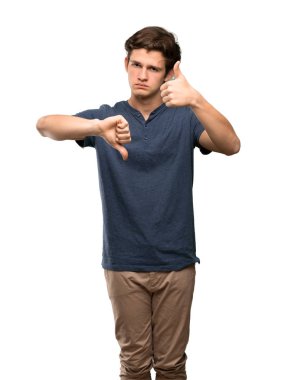 İyi-kötü işaret yapma genç adam. Kararsız Evet arasında veya izole beyaz arka plan üzerinde değilken