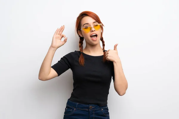Young Redhead Woman White Wall Showing Sign Giving Thumb Gesture — Stock Photo, Image