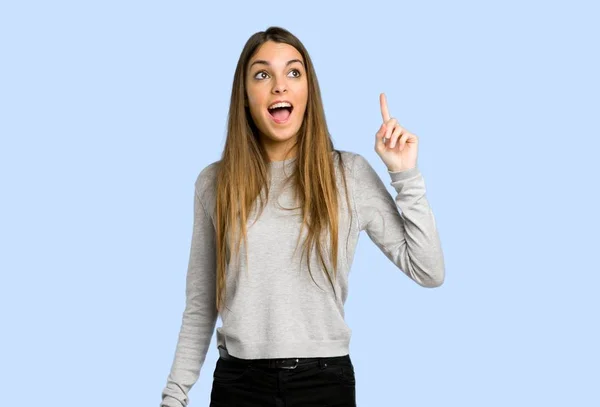 Young Girl Intending Realizes Solution While Lifting Finger Blue Background — Stock Photo, Image