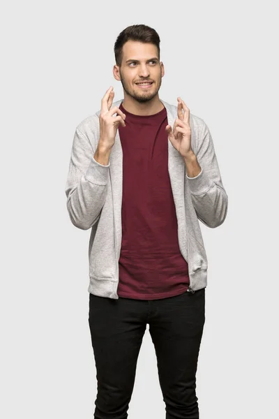 Man Sweatshirt Fingers Crossing Wishing Best Grey Background — Stock Photo, Image