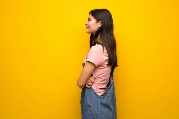 Teenagermädchen Über Gelbe Wand Seitenlage — Stockfoto