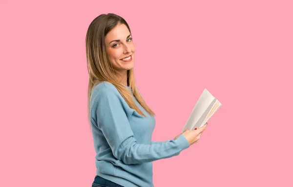 Blonde Woman Blue Shirt Holding Book Enjoying Reading Isolated Pink — Stock Photo, Image