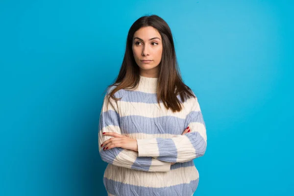 Young woman over blue wall portrait