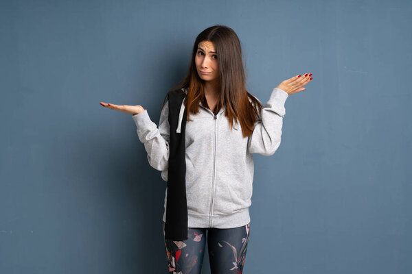 Young sport woman making doubts gesture