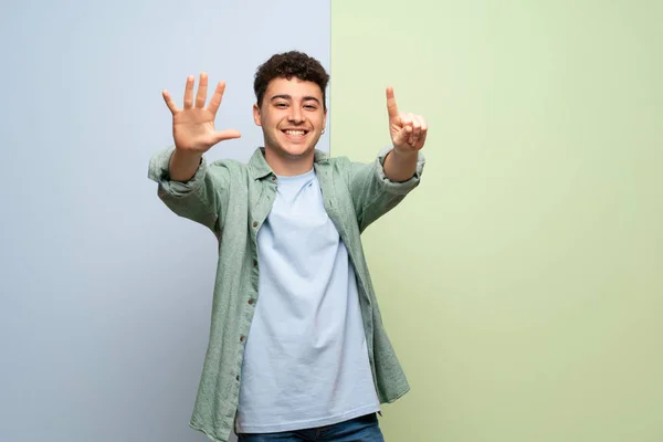 Young Man Blue Green Background Counting Six Fingers — Stock Photo, Image