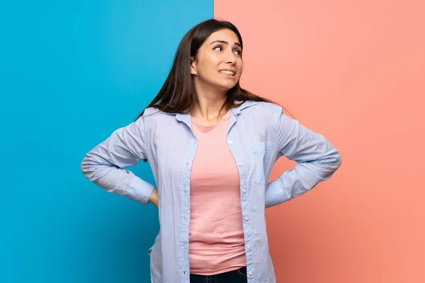 Young Woman Pink Blue Wall Suffering Backache Having Made Effort — Stock Photo, Image