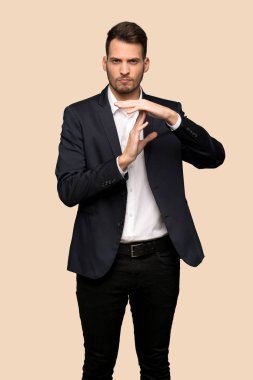 Yakışıklı iş adam yapma zaman aşımı jest koyu sarı arka plan üzerinde