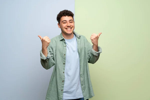 Young Man Blue Green Background Giving Thumbs Gesture Both Hands — Stock Photo, Image