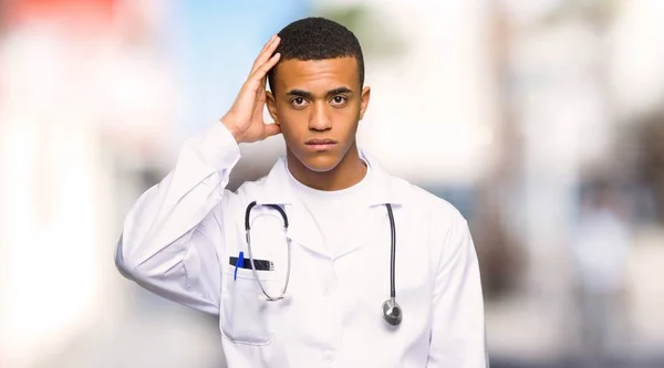 Young afro american man doctor with an expression of frustration and not understanding at outdoors