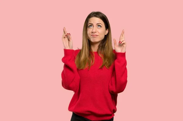Young Woman Red Sweater Fingers Crossing Wishing Best Isolated Pink — Stock Photo, Image
