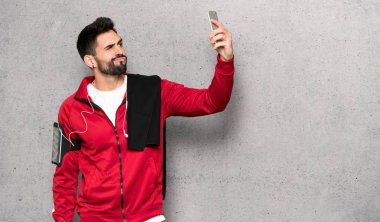 Yakışıklı sportman dokulu duvar'ın üstüne bir selfie yapma