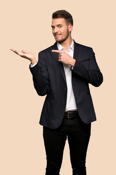 Handsome Business Man Holding Copyspace Imaginary Palm Insert Ocher Background — Stock Photo, Image