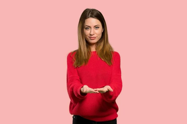 Young Woman Red Sweater Holding Copyspace Imaginary Palm Insert Isolated — Stock Photo, Image