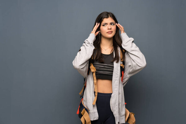 Teenager traveler girl over wall with headache