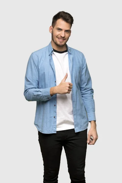 Handsome Man Giving Thumbs Gesture Smiling Grey Background — Stock Photo, Image