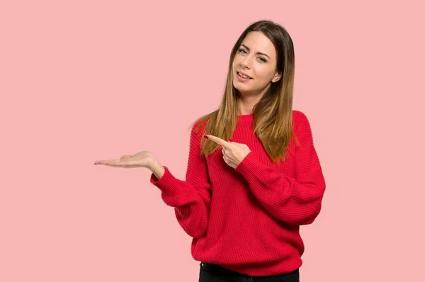 Young Woman Red Sweater Holding Copyspace Imaginary Palm Insert Isolated — Stock Photo, Image