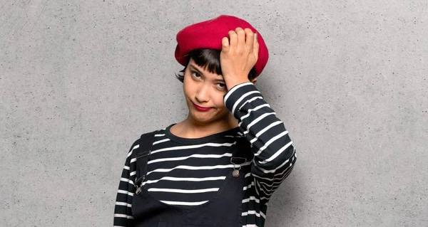 Young Woman Beret Frustrated Takes Hands Head Textured Wall — Stock Photo, Image