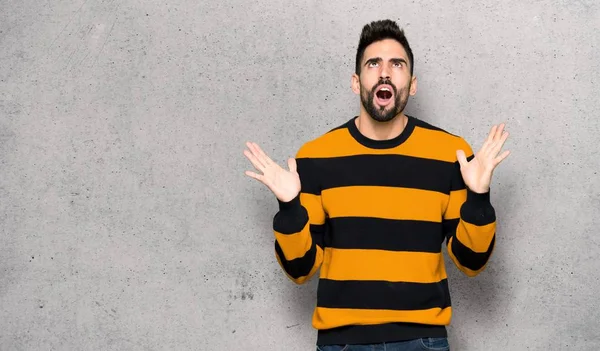 Handsome Man Striped Sweater Frustrated Bad Situation Textured Wall — Stock Photo, Image